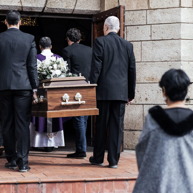 Death, funeral and people with coffin to church, chapel service and ceremony for temple ritual. RIP.