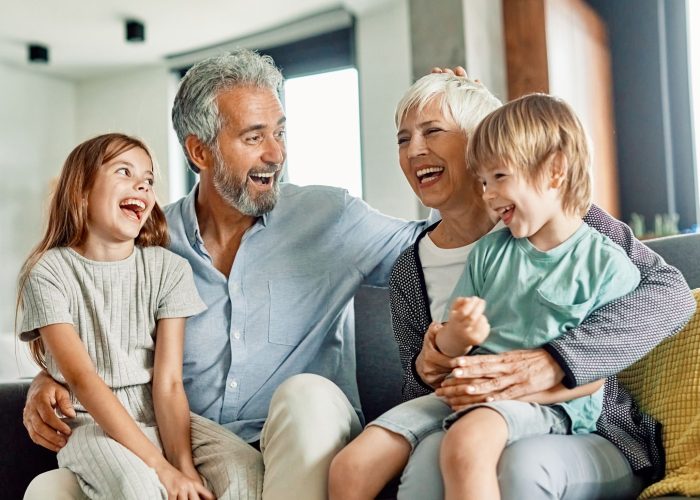 happy-family-laughing-together-sitting-on-a-sofa-2026-03-26-23-21-57